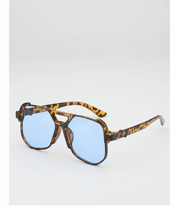 Detail view of oversized tortoise sunglasses with blue lenses and double bridge design