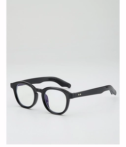 Close-up of black round sunglasses frame with anti-slip temple tips and gold rivet details