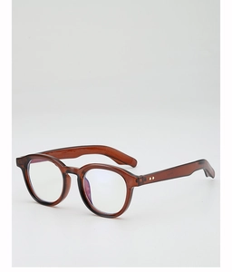 Detail of amber tortoiseshell round glasses frame with metal rivets and blue tint lenses