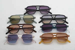 Various colors of pilot sunglasses with metal rivets and gradient lenses on white