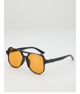 Detail of oversized sunglasses with black frame and vibrant orange lenses at 45-degree angle