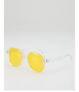 Detail view of oversized pilot sunglasses with yellow ocean lenses and transparent frame