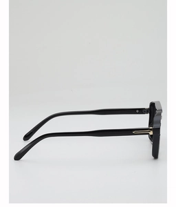 Detail view of black square sunglasses with decorative gold metal piece on the temple