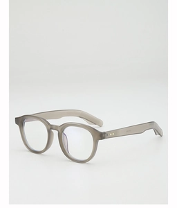 Detail of round translucent taupe sunglasses with metallic rivets and blue-tinted lenses