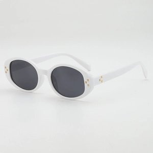 White oval frame sunglasses with dark lenses and gold X-shaped metal accents on white background