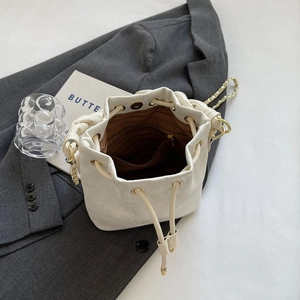 Top view of white leather bucket bag interior showing brown lining and magnetic closure