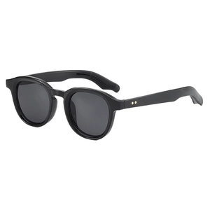 Retro black round frame sunglasses with gold rivet accents on 45-degree angle white view