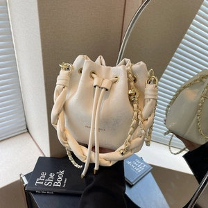 Winter cream drawstring bucket bag with woven handle and gold chain strap for women