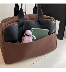 Detailed view of canvas tote bag interior showing spacious capacity with tablet and umbrella