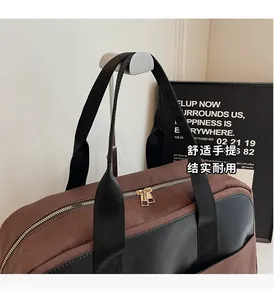 Detail of canvas and leather patchwork tote with golden double zippers and nylon handles