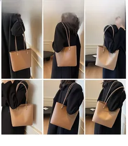 Detailed views of woman wearing large capacity tote bag in brown and beige tones