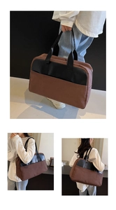 Close-up of large capacity travel shoulder bag in dark brown canvas with black handles
