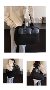 Detail of a large black travel tote bag showing versatile carrying methods and large capacity
