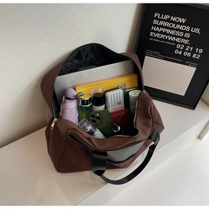 Detailed internal view showing large capacity for laptop and daily essentials in brown bag