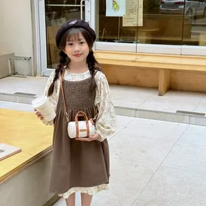 Close-up of girl wearing floral shirt, corduroy dress, and black beret with metal logo
