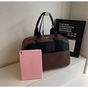 Brown canvas handbag with black leather trim and pink tablet showing large capacity