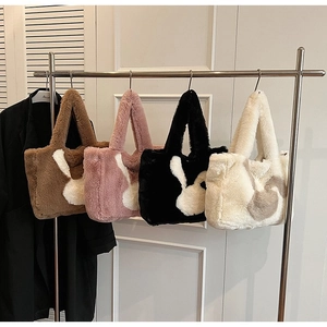 Row of plush tote bags in brown, pink, black, and white with cute rabbit ear designs