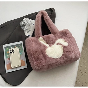 Detail of pink faux fur tote bag with cute white rabbit embroidery and fluffy texture