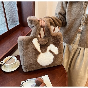 Brown faux fur tote bag with white rabbit pattern shown in a cozy lifestyle setting