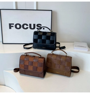 Three retro plaid patchwork crossbody bags in black, coffee, and brown displayed on white stands
