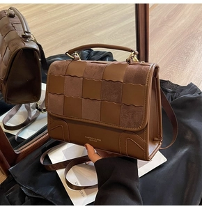 Close-up of brown patchwork crossbody bag with checkered suede and leather wave textures