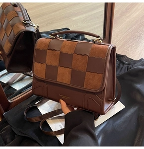Detailed view of vintage brown patchwork handbag with checkered weave pattern and strap