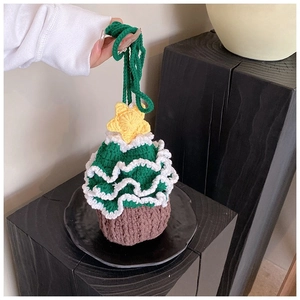 Detail of hand-knitted Christmas tree shoulder bag with 3D star and snow ruffle edge