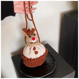 Detail of a handmade knitted reindeer shoulder bag with red nose and 3D antlers