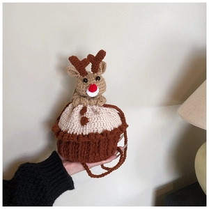 Close-up of handmade crochet reindeer cupcake bag with detailed woven texture and strap