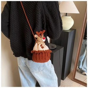 Detail view of handmade crochet reindeer shoulder bag with red nose and 3D antlers