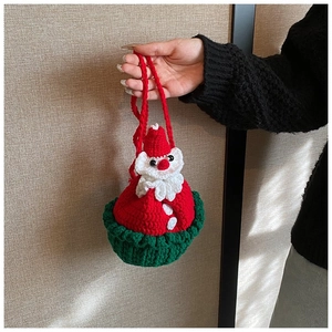 Detailed close-up of a handmade crocheted Santa Claus festive drawstring handbag with handles