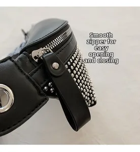 Detail of black leather bag with silver zipper and dense metal rivet decorations