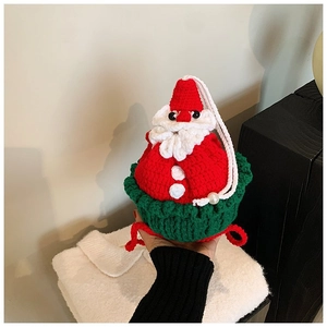 Macro shot of hand-knitted Santa bag with pearl detail and festive crochet texture