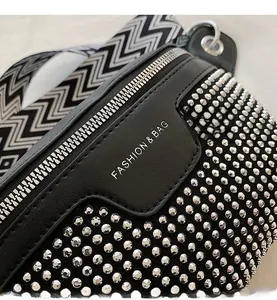Detail of black PU leather bag with silver studs and FASHION & BAG lettering
