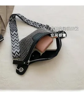 Interior detail of black punk studded waist bag showing large capacity with wallets