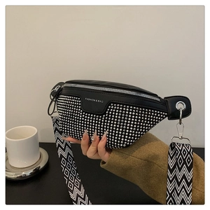 Close-up of black PU leather waist bag with silver rivets and geometric strap detail