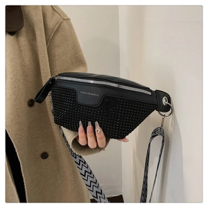 Detail of black PU waist bag featuring rhinestone studs and geometric woven strap
