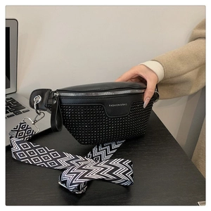 Detail of black PU fanny pack with sparkling rhinestones and geometric pattern strap