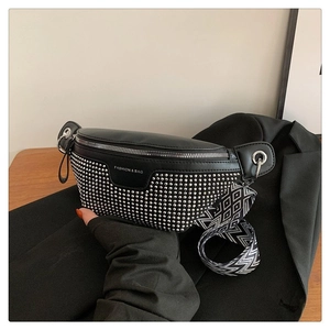 Detail of black crossbody chest bag with silver metal studs and wide patterned strap