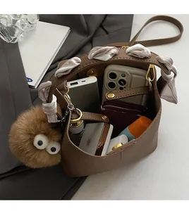 Top view of brown leather bucket bag interior showing capacity for phone and wallet