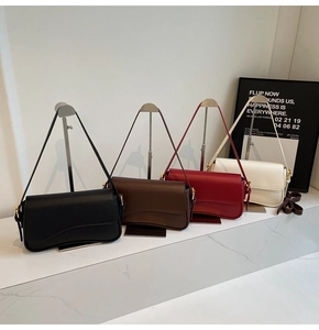 Detail of four chic leather crossbody bags in black, brown, red, and white with flap design