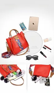 Detail view of red PU leather tote bag showing internal storage capacity for iPad and makeup