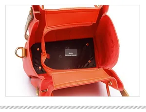 Interior view of orange PU handbag showing main pocket and side zipper pocket detail