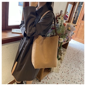 Detail of camel suede minimalist shoulder bag with spacious design for daily commute