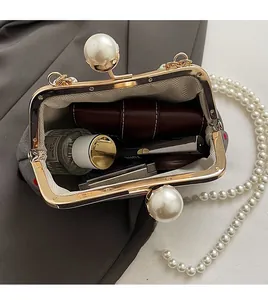 Interior view of the gray pearl chain evening bag showing space for lipstick and perfume