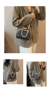 Detailed view of polka dot evening bag with gold frame and large pearl clasp