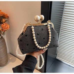 Detail of vintage gray herringbone polka dot bag with large pearl clasp and chain