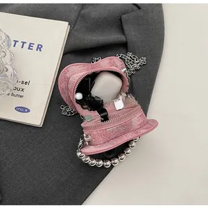 Pink heart-shaped mini bag interior showing capacity for earphones and lipstick