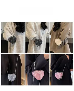Detailed view of heart-shaped nylon handbags with pearl handles and metallic chain straps