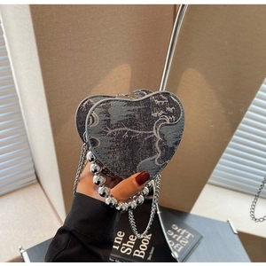 Detail of heart-shaped handbag with grey landscape jacquard fabric and silver bead handle